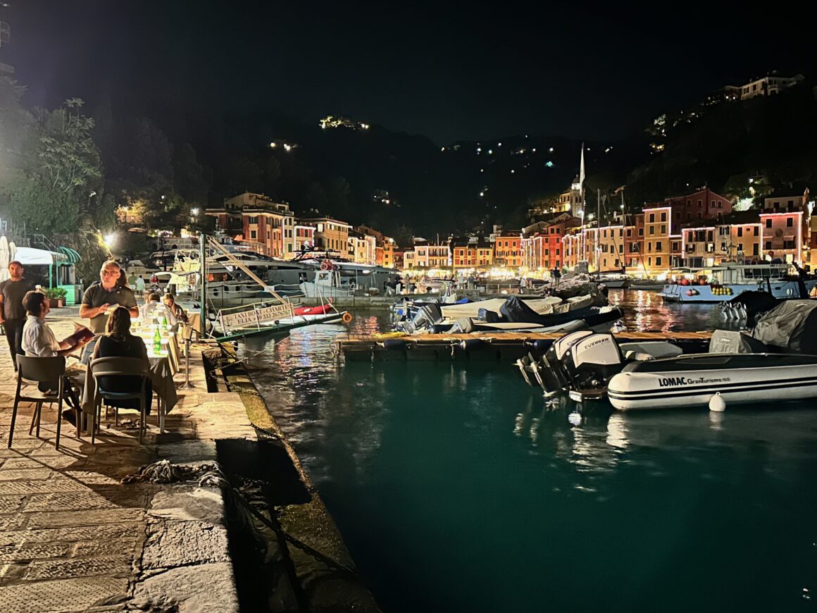 candlelit dinner table by waters edge in portofino italy